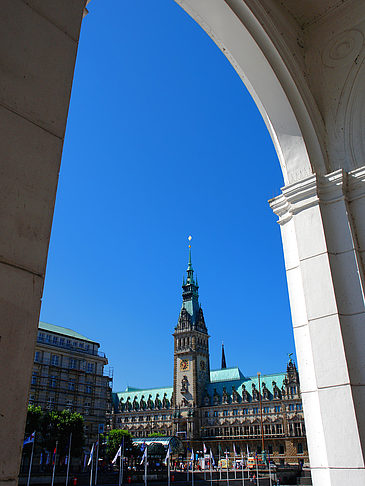 Foto Blick durch die Bögen der Alster Arkaden auf das Rathaus